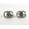 A pair of Gucci Italian 18ct white gold and diamond set earrings, in the form of the double G monogr... 