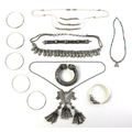 A collection of Cambodian, Burmese and South East Asian vintage white metal jewellery, comprising a ... 