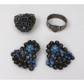 A pair of white metal ear-clips, likely Russian silver, with turquoise cloisonne detail amongst flor... 