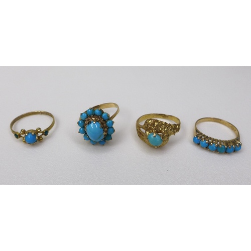 132 - A group of four Middle Eastern gold rings, of varying designs but all set with turquoise, each unmar... 