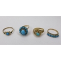 A group of four Middle Eastern gold rings, of varying designs but all set with turquoise, each unmar... 