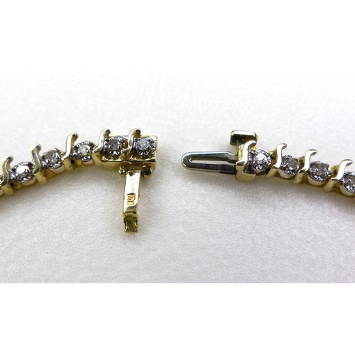 141 - A modern 10K yellow gold and diamond set bracelet, with forty-six round brilliant cut illusion set d... 