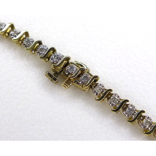 141 - A modern 10K yellow gold and diamond set bracelet, with forty-six round brilliant cut illusion set d... 