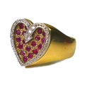 A 9ct gold, diamond and ruby valentine heart ring, formed of eighteen rubies within a recessed heart... 