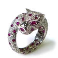A 18ct white gold, diamond and ruby ring in the form of a coiled panther, by Brooks & Bentley, Londo... 