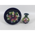 A Moorcroft bowl in the Hibiscus pattern, on a midnight blue ground, 25cm, together with a Moorcroft... 