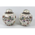 A pair of early 20th century Chinese porcelain ginger jars and covers, decorated as a mirrored pair,... 