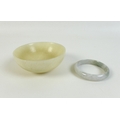 A Chinese mutton fat jade bowl, 11 by 4.5cm, together with a pale green and white jade bangle, 6cm i... 