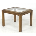A modern wooden side table, with inset glass surface, carved border, raised on square section legs, ... 