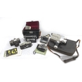 A group of vintage cameras and camcorders, including a Polaroid Instamatic camera, some with origina... 