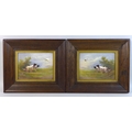 A pair of Edwardian Crown Devon Fieldings painted ceramic plaques, by R. Hinton, each depicting two ... 