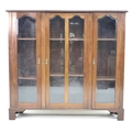 A mid 20th century mahogany glazed bookcase, with three glazed doors each enclosing two adjustable s... 