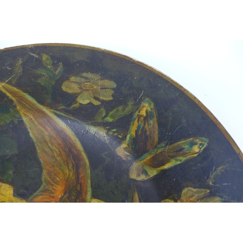 47 - A Victorian paper mache plate, depicting a tropical bird with open wings, surrounded by folliage, 32... 