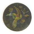 A Victorian paper mache plate, depicting a tropical bird with open wings, surrounded by folliage, 32... 