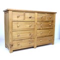 A modern pine chest of drawers, with an arrangement of four short over six long drawers with turned ... 