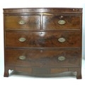 A Regency mahogany bow fronted chest of two short over two long drawers, with cock beading and oval ... 