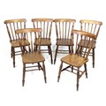 A set of six Victorian oak stick back Windsor dining chairs, with shaped seats and turned legs joine... 