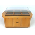 A modern shop display cabinet unit, with glazed box showcase to the surface comprising six sliding d... 