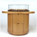 A modern shop display cabinet unit, with cylindrical glazed box showcase to the surface enclosing re... 