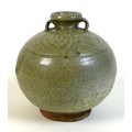 A Chinese pottery celadon glaze two handled jar, probably Ming Dynasty, incised leaf form decoration... 