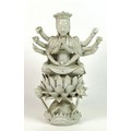 A Chinese blanc de chine figure, Qing Dynasty, 19th century, modelled as Guanyin with ten arms, seat... 