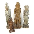 A group of four wooden carvings, comprising a Chinese carving of a man holding a flower aloft, 20cm,... 