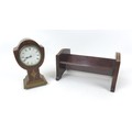 An early 20th century tulip form mantel clock, with Roman numeral dial, walnut veneered case with wa... 
