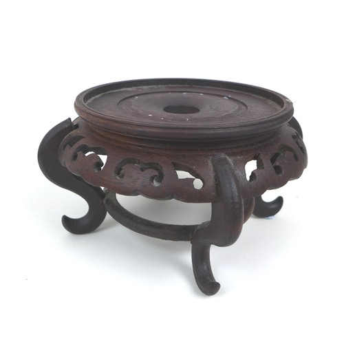 24 - A group of nine oriental hardwood stands, of different styles, largest 18.5cm diameter, 3.5cm high, ... 