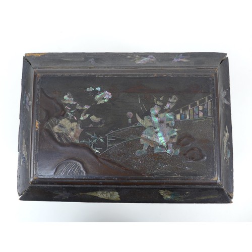 17 - A 19th century chinoiserie tea caddy of sarcophagus form, with mother of pearl inlaid floral and rel... 