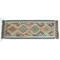 A vegetable dyed wool Choli Kelim runner, with four large diamond medallions to the field and geomet... 