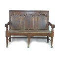 A small 18th century oak settle, with three panelled back rest, moulded armrests, turned supports, r... 