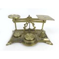 A set of Victorian brass postal scales, with six weights, with relief foliate decoration to its base... 