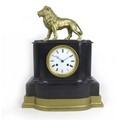 A 19th century French black slate mantel clock, with gilt lion surmount, Roman numeral enamel dial, ... 