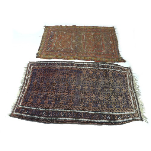 172 - Two hand knotted woolen rugs, one with a dark blue ground and an orange geometric design with white ... 