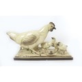 A French mid to late 20th century ceramic figural group, modelled as a hen with chicks and a snail, ... 