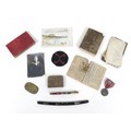 A collection of WWII Japanese ephemera, comprising a Red Cross medal with blue rosette, a Japanese b... 