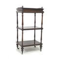 A Victorian rosewood three tier whatnot, with plain 3 quarter gallery and single drawer to top, turn... 