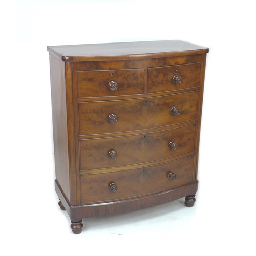 221 - A Victorian bow fronted figured mahogany chest of drawers, with two over three drawers, raised upon ... 