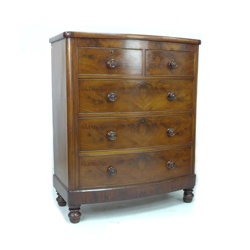 221 - A Victorian bow fronted figured mahogany chest of drawers, with two over three drawers, raised upon ... 