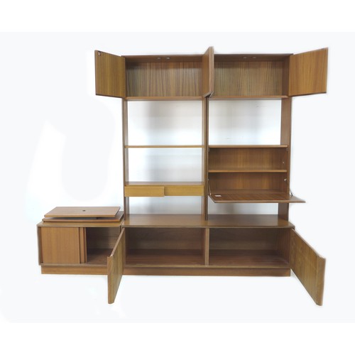 187 - A G-Plan teak wall display shelving system, circa 1970, comprising two high level cupboard units, a ... 