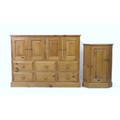 A modern pine cupboard, with two double doors over an arrangement of six drawers, with turned knobs,... 