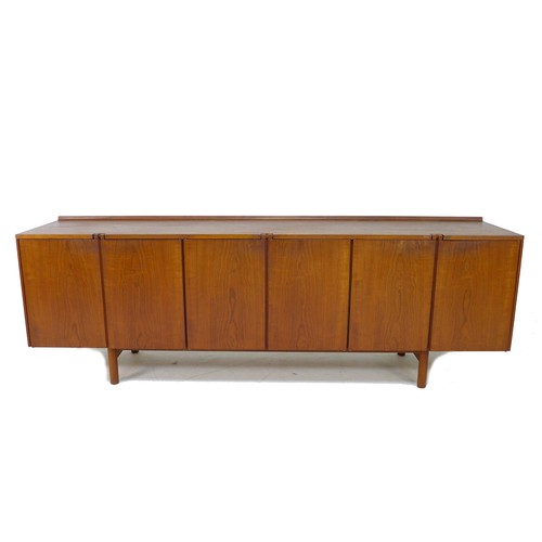 188 - A British teak sideboard, Robert Heritage for Archie Shine, of long low form with small shaped upsta... 