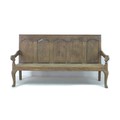 A late 18th century oak settle, with five section panelled back, shaped arm rests, raised on cabriol... 
