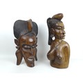 Two modern African carvings, one carved as a mask with headdress, 28 by 16.5 by 48.5cm long, the oth... 