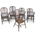 A group of five Windsor armchairs, comprising a late 18th century elm and oak Windsor stamped 'W. P.... 
