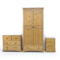 A modern pine bedroom suite, comprising a two door wardrobe, 86 by 52 by 180, a chest of two over tw... 