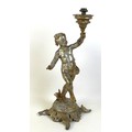 A 19th century cast metal table lamp, possibly French, in the form of a cherub holding the lamp fitt... 
