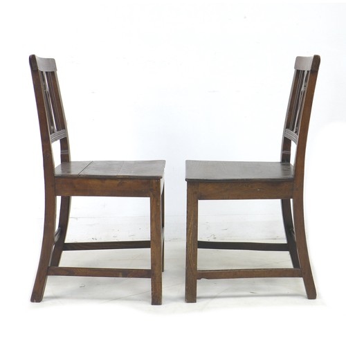 203 - Two George III oak chairs, with pierced slats, solid seats, and square fore legs and rear sabre legs... 