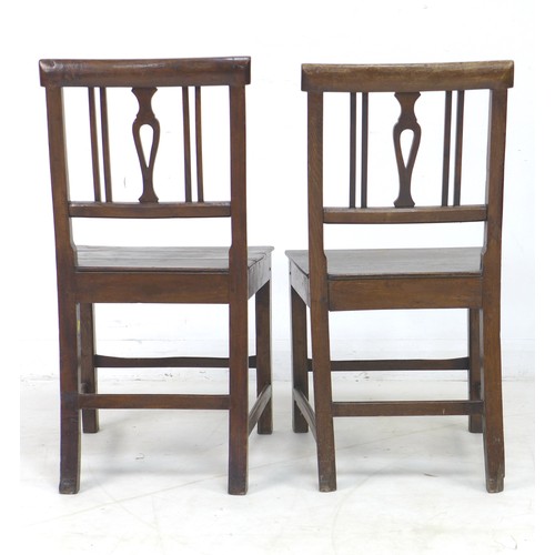 203 - Two George III oak chairs, with pierced slats, solid seats, and square fore legs and rear sabre legs... 