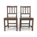 Two George III oak chairs, with pierced slats, solid seats, and square fore legs and rear sabre legs... 